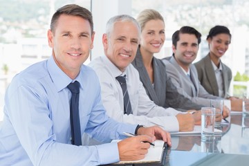 Business team smiling at camera during conference