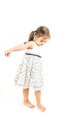 Cute little girl standing barefoot isolated