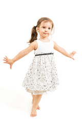 Cute little girl standing barefoot isolated