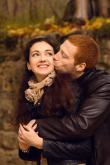 Happy young couple in love meeting on the autumn leaf