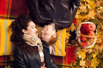 Happy young couple in love meeting on the autumn leaf