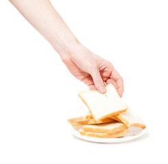 male hand tacking piece of bread for toasts