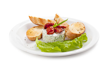 Ricotta salad decorated with sun-dried tomatoes and lettuce