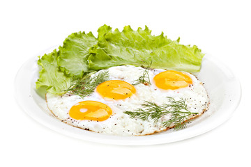Plate of traditional breakfast with fried eggs and herbs