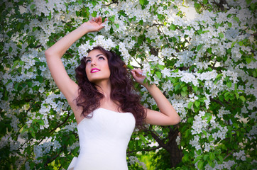 Bride in blooming apple trees