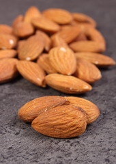 Heap of almonds on concrete structure