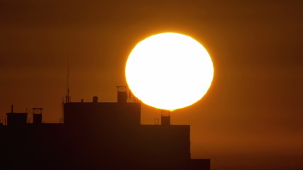 4 in 1 video! The sunrise above city buildings roof - extreme close up telescope view. Shot with Red Cinema Camera - Powered by Adobe