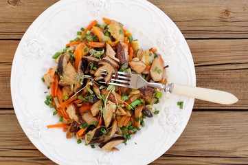 Porcini mushrooms ragout with carrot, scallion and thyme in whit
