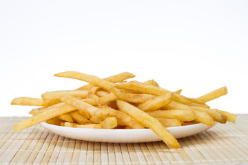 Potatoes fries in a little white paper bag on wood board