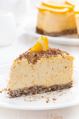 piece of orange cheesecake on a plate, vertical, close-up