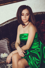 photo of gorgeous woman with dark hair in elegant green dress