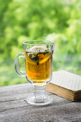 green tea with lemon and mint and a book