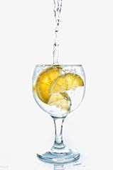 Cocktail with ice and lemon isolated on white background