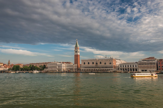 Campanile tower at Piazza San Marco and gondolers, Venice, Italy