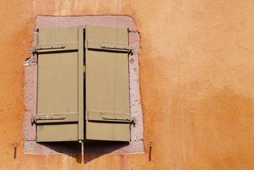 brown folding shutter of an orange house