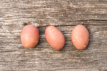 Potatoes on wooden background