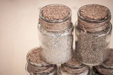 small glass jars with sand and stones from the beach