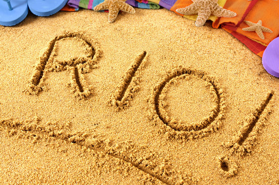 Rio word written in sand on a sandy Rio De Janeiro beach background with star fish and accessories Brazil summer tropical holiday vacation photo