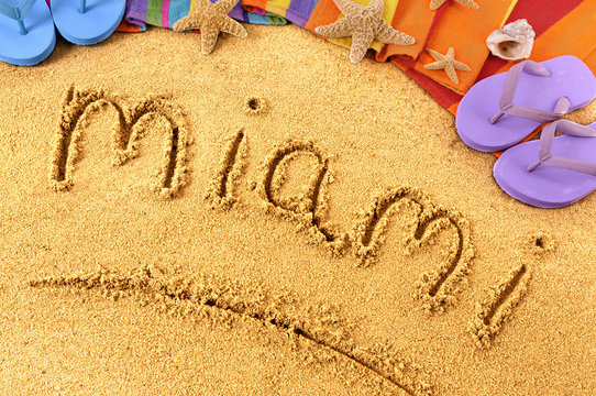 Miami word written in sand on a sandy beach background with star fish and accessories summer Florida holiday vacation photo