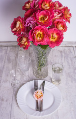 beautiful table setting with roses bouquet