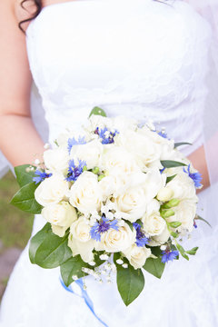 Brides wedding bouquet and wedding dress.