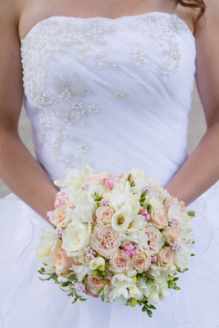 Brides wedding bouquet and wedding dress.