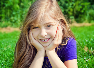 Fototapeta premium young girl lying on grass