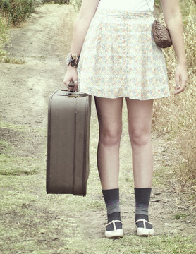 Girl Traveling Down Path with Suitcase