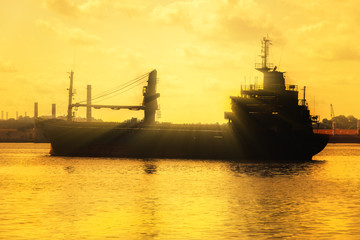 Commercial cargo ship at sunset