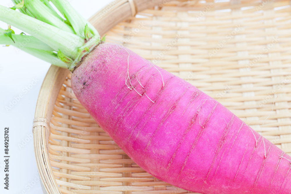 Wall mural large and fresh purple daikon radish in bamboo tray