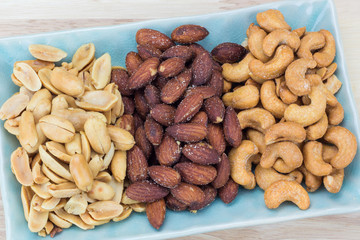salted variety nut on wooden background