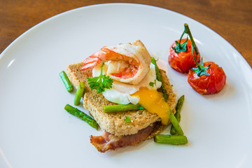 Sandwich with poached egg, parma ham and tomato