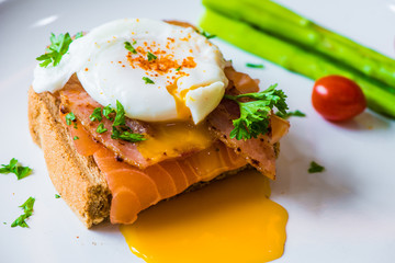 Sandwich with poached egg, parma ham and Salmon