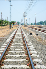 Fototapeta na wymiar Vacant Rail way switch track with yellow die grass.