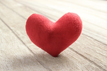 red heart shape on wood background