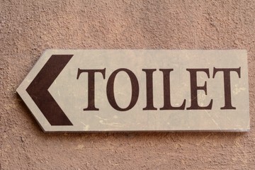 Symbolize toilets on wall background