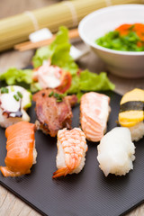 Sushi assortment on black dish, close up
