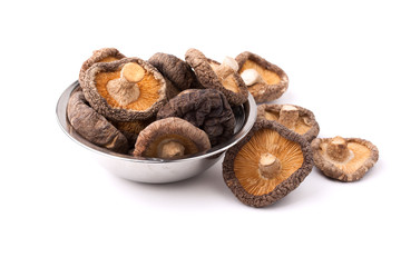 dry shitake mushroom in stanless bolw on white background