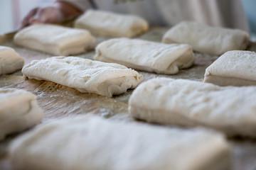 Baker Holding Tray of Ciabatta Bread Rolls