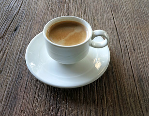 Cup of coffee on wooden background