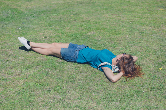 Young woman lying on grass in the park