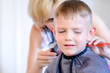 Little boy unimpressed with his haircut