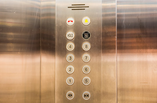 Stainless steel elevator panel push buttons.