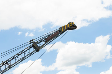 Old Crane or Metal Structure and Sling on Blue Sky at Side View