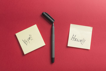 Two hand written notes isolated on red background