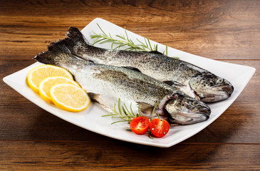 Fresh raw trout on wooden background 