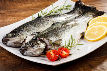 Fresh raw trout on wooden background 