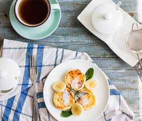 cottage cheese pancakes with banana, powdered sugar and fresh mi