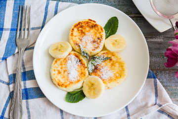 cottage cheese pancakes with banana, powdered sugar and fresh mi
