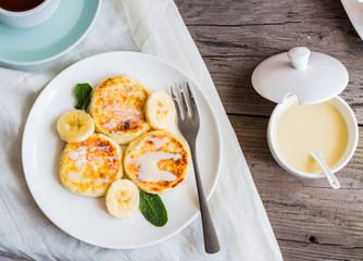 Homemade cottage cheese pancakes  with banana, condensed milk,br